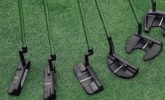 A modern golf putter on the green