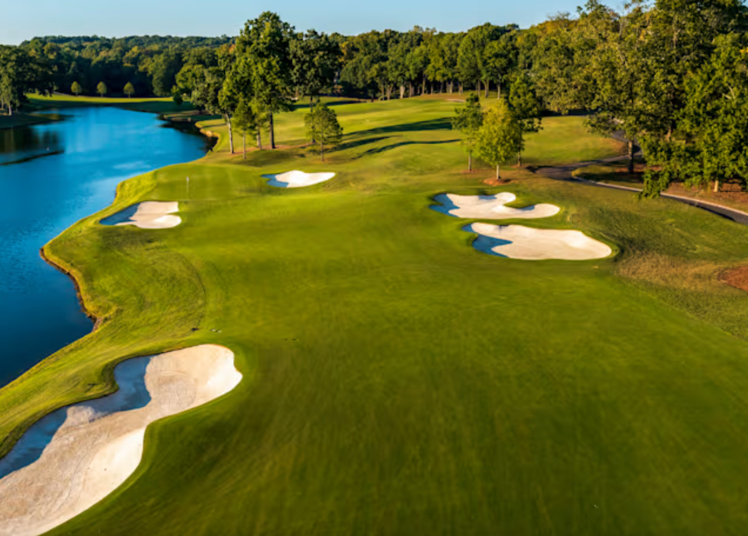 A long par 4 with water and bunkers viewed from the championship tee