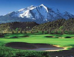 A mountain peak forming the backdrop of a golf green