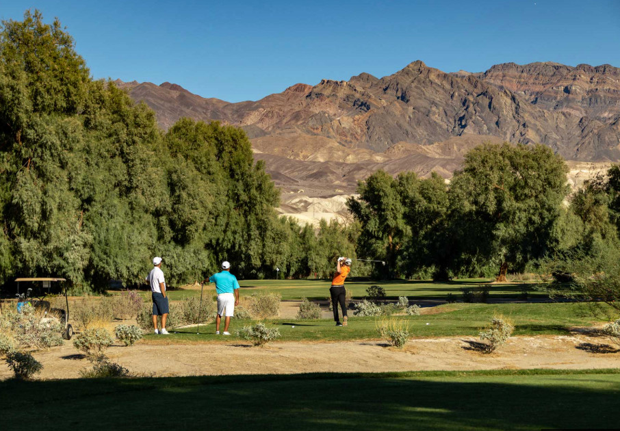 Palm trees and desert mountains at Furnace Creek golf course
